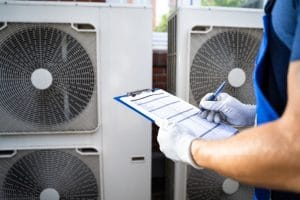 HVAC professional performing 24 hour AC repair inspection